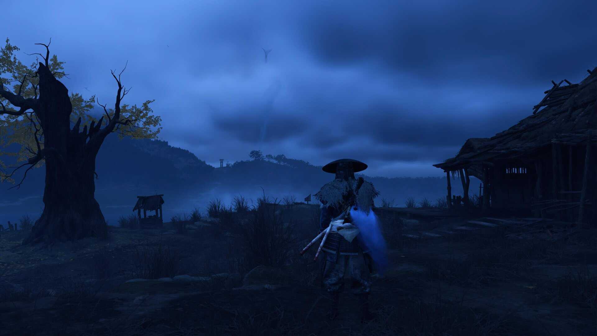 A woman standing near the ruins of a small house, a burned out ginko tree nearby.
