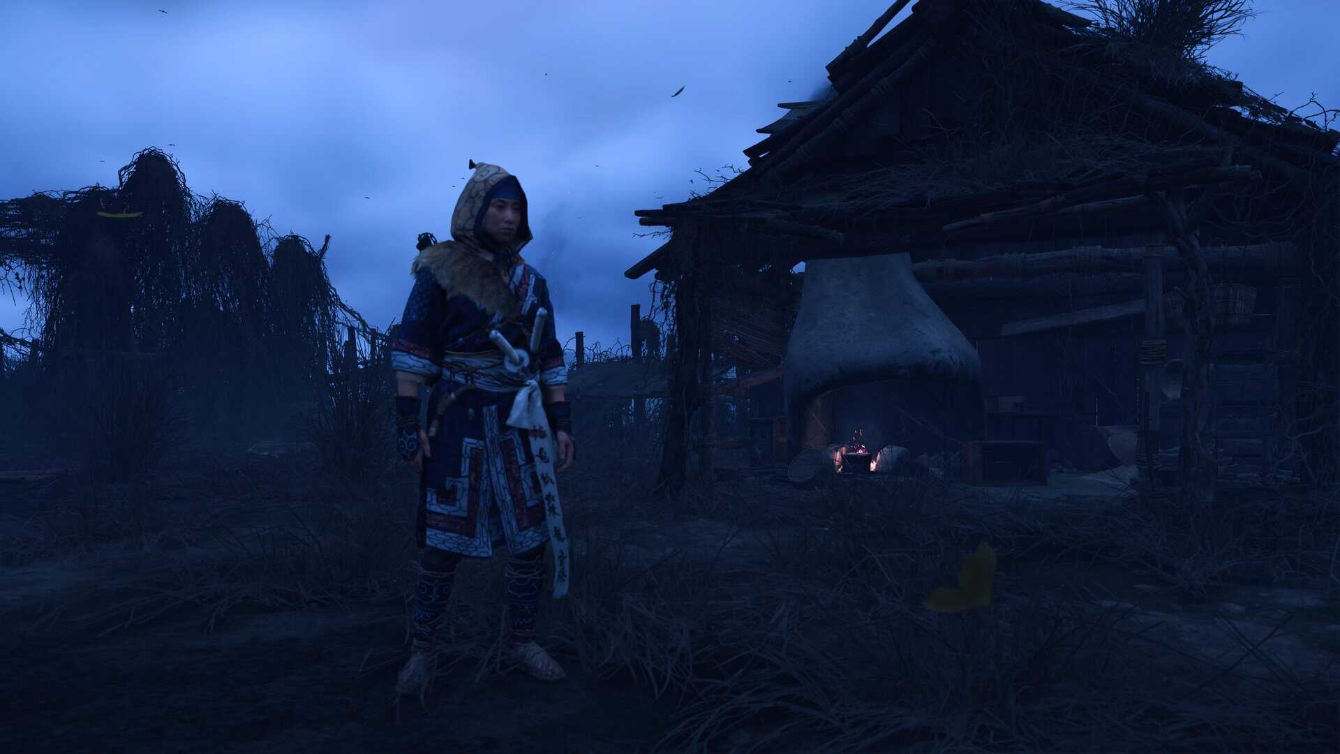 A woman in Ainu cultural clothing next to a Japanese forge.