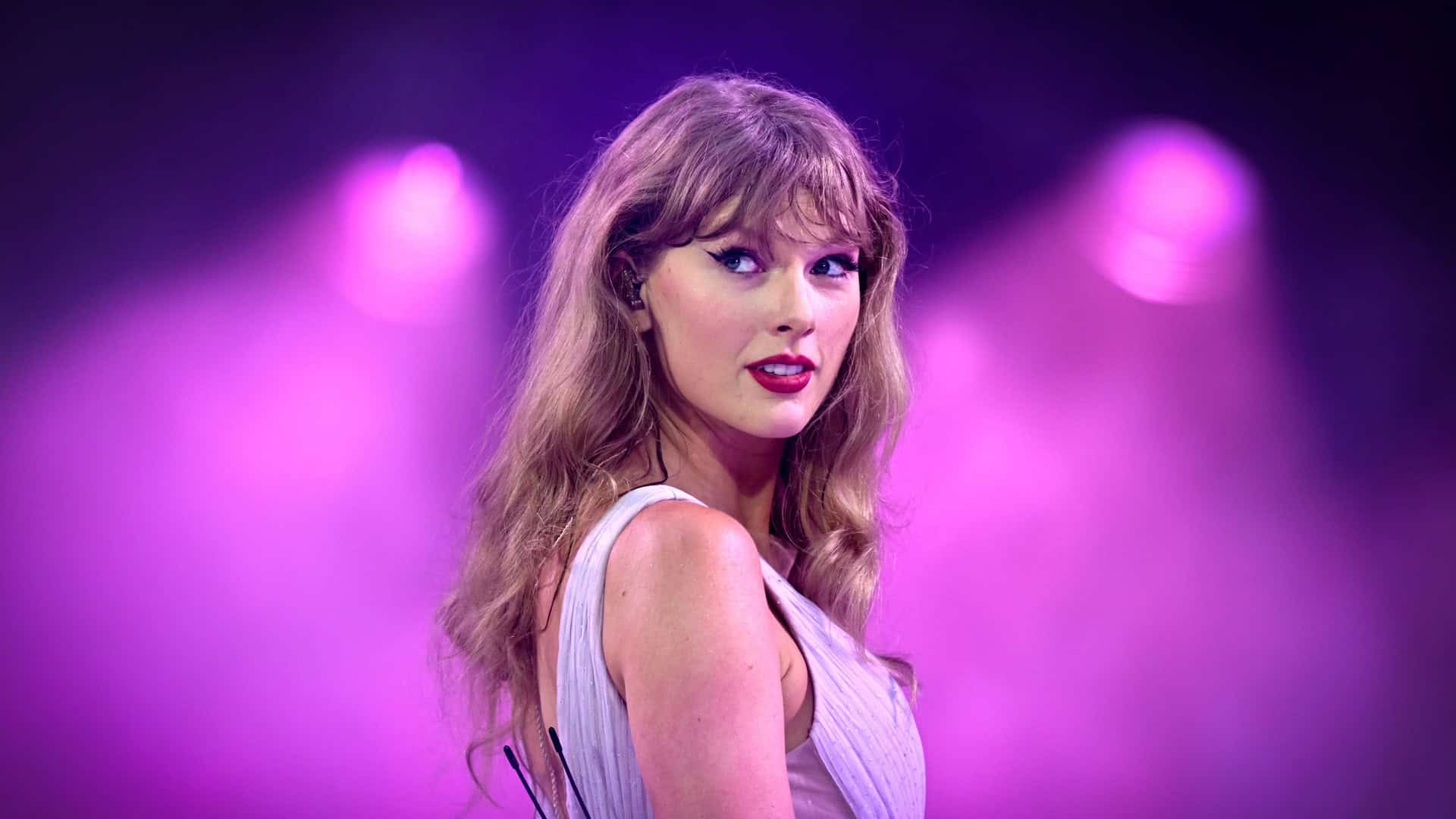 Taylor Swift from the Speak Now set in Eras tour, wearing a purple outfit