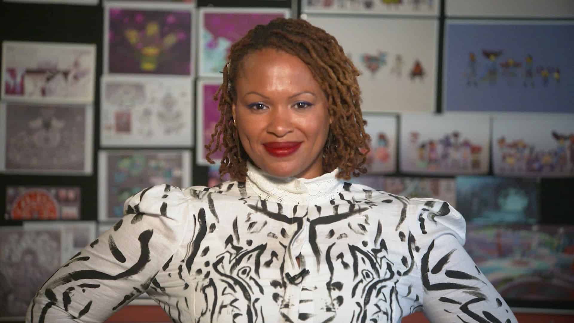 Picture of Lisette Titre-Montgomery with the art she contributed for DoubleFine in the background