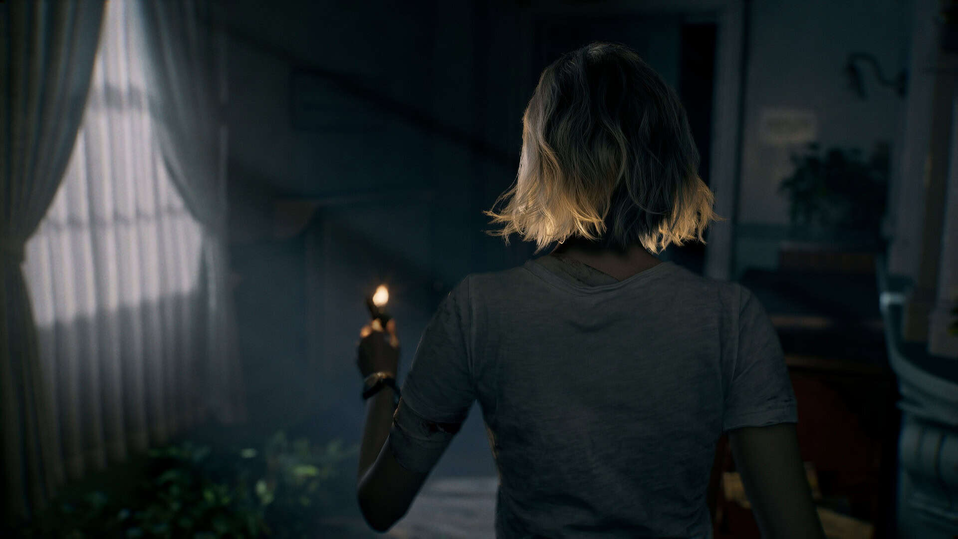 A screenshot of Grace in Resident Evil Requiem, with the camera looking over her shoulder as she investigates a dark room