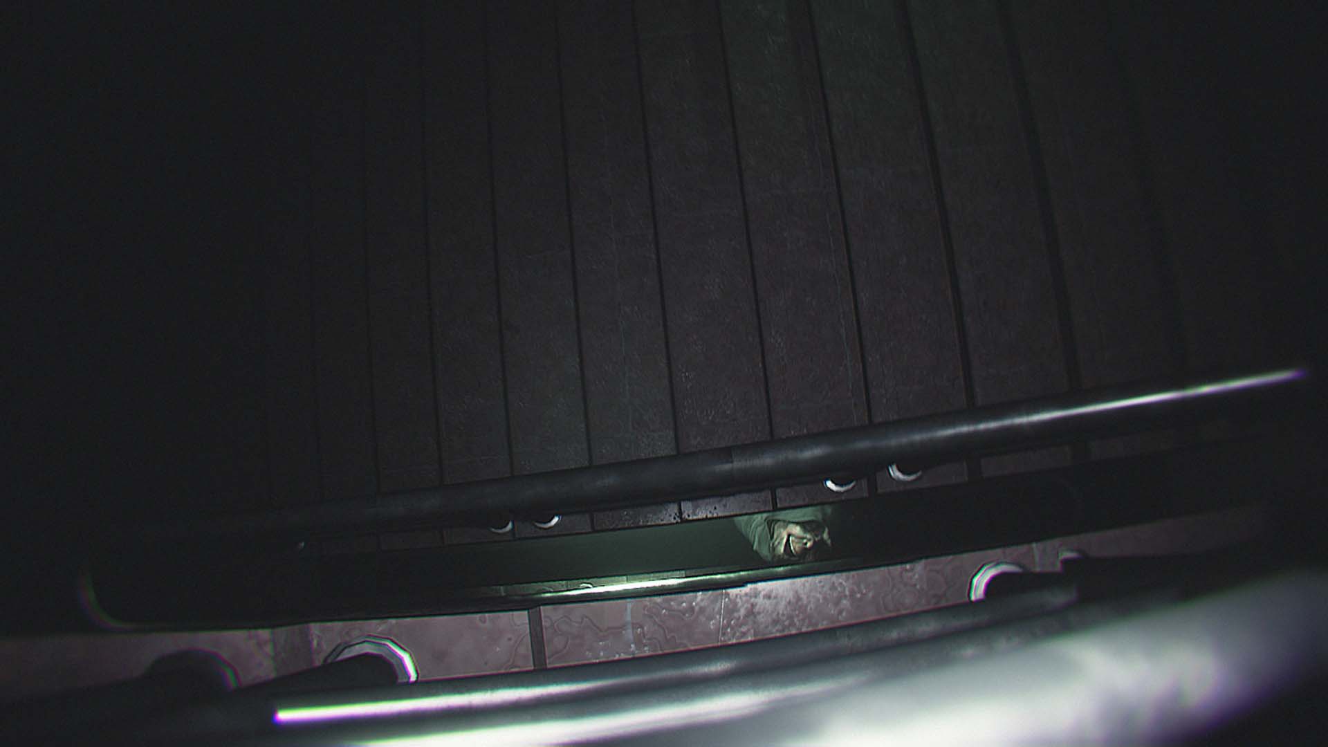 The stalker's face seen down a staircase in Dread Neighbor.