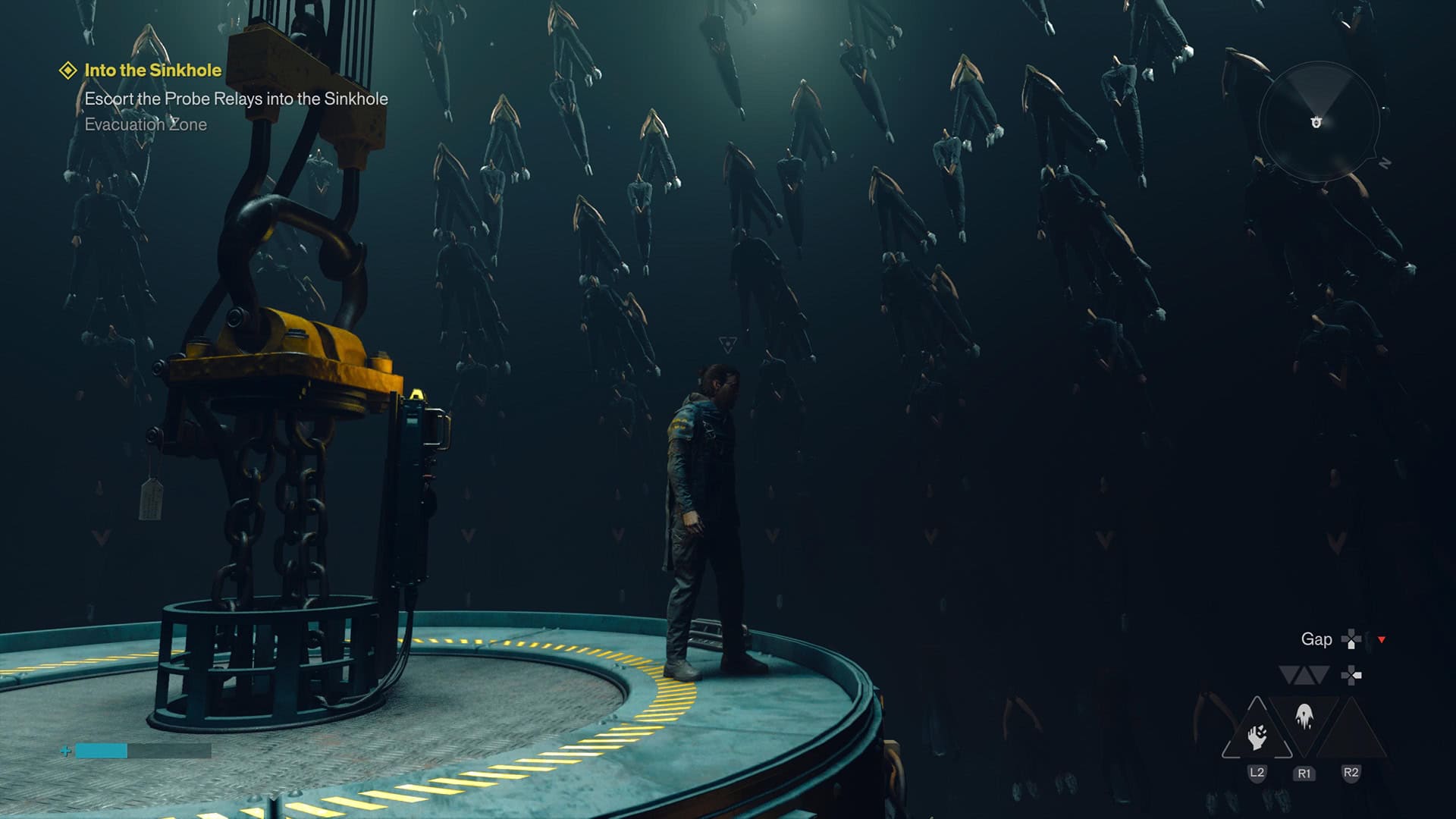 A white man looks out on the edge of a circular platform while a load of human bodies in suspended animation circle him.