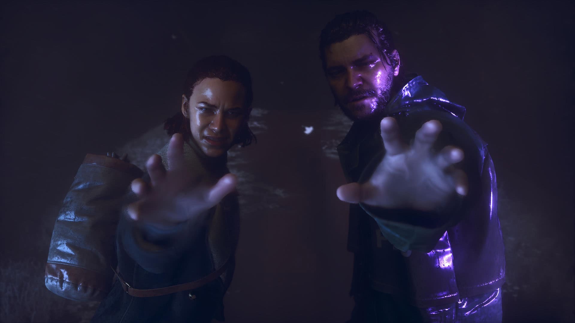 A woman (left) and a man (right) reach their hands towards the camera, and the man is slightly covered in a purple light.